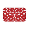 Memory foam floor mat with a single flower petal burst design in red with a white background. The center flower petals form a star pattern with all the other flower petals bursting out from the center.