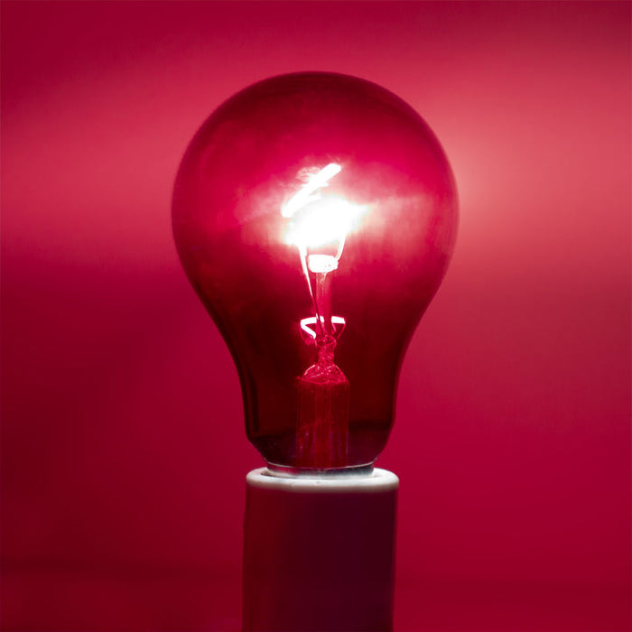 Chromalux Unwind Red Incandescent Light Bulb For Sleep illuminating a dark space with a warm red glow.