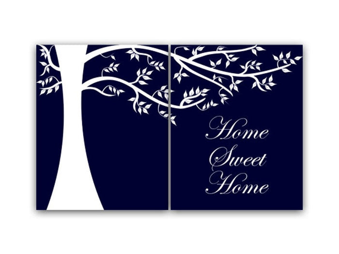 A 2-panel art print with a navy blue background featuring a hand-drawn, white tree silhouette on the left panel and the phrase 'Home Sweet Home' written in a white, cursive script on the right panel. The tree limbs and leaves connect the two panels across the top.